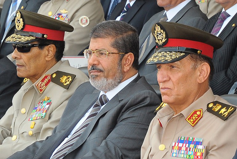 FORCED RETIREMENT. A handout picture released by the Egyptian presidency on July 9, 2012 shows Egyptian President Mohamed Morsi (C), head of the military council Field Marshal Mohammed Hussein Tantawi (L) and armed forces chief Sami Anan (R) attending a graduation ceremony of military cadets in Cairo. Morsi replaced Defence Minister Tantawi and sent him into retirement, official news agency MENA reported on August 12, 2012, adding that Anan was also retired. AFP PHOTO/EGYPTIAN PRESIDENCY