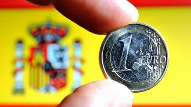 BYE, RECESSION. Spain is no longer in a recession. AFP file photo shows a euro coin with a Spanish national flag in the background