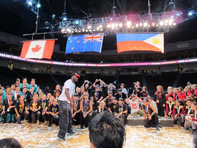 FLAGS UP. A Hip Hop International crew member giving the Megacrew teams some inspiring words after the awarding ceremony. 