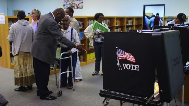 FLORIDA VOTES. Voters prepare to cast their ballots at the North Miami Public Library after standing in line on November 1, 2012 in North Miami, Florida. Joe Raedle/Getty Images/AFP
