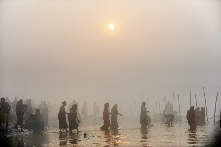 KUMBH MELA. Devotees walk into the waters at the Sangham or confluence of the Yamuna and Ganges river during day break at the Kumbh Mela celebration in Allahabad on January 13, 2013. AFP PHOTO/ROBERTO SCHMIDT