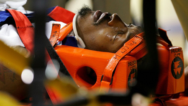DOWN AND OUT. Gerald Wallace is strapped to a gurney after suffering from a concussion. Photo by Streeter Lecka/AFP