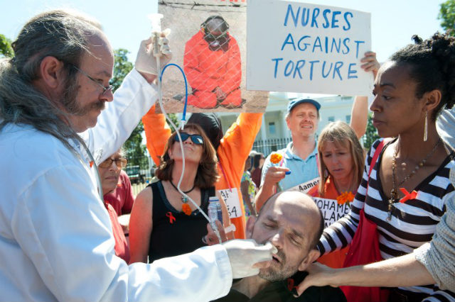 'ENDLESS AGONY.' Protester Andrés Thomas is force-fed during a demonstration in solidarity with hunger-striking inmates at Guantanamo Bay. Photo by AFP