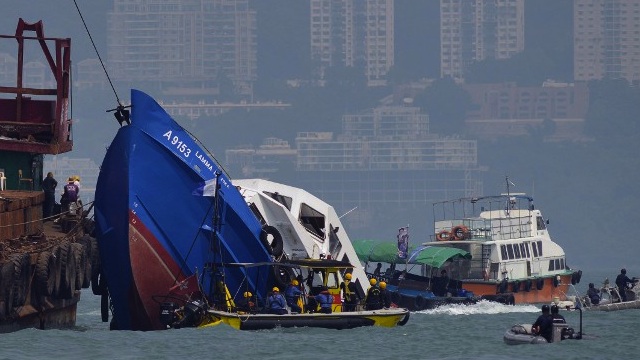 SALVAGE. The bow of the Lamma IV boat (L) is seen partially submerged during rescue operations on October 2, 2012 the morning after it collided with a Hong Kong ferry killing over 30 people. File photo by Antony Dickson/AFP