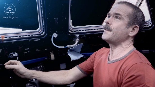 HADFIELD DOES BOWIE. Chris Hadfield in a dramatic moment on his farewell music video to the International Space Station. Screen shot from YouTube