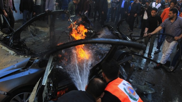 AIRSTRIKE AFTERMATH. Palestinian firefighters extinguish fire from the car of Ahmaed Jaabari, head of the military wing of the Hamas movement, the Ezzedin Qassam Brigades, after it was hit by an Israeli air strike in Gaza City on November 14, 2012. The top Hamas commander Ahmed al-Jaabari was killed in an Israeli air strike , medics and a Hamas source told. AFP PHOTO/MAHMUD HAMS