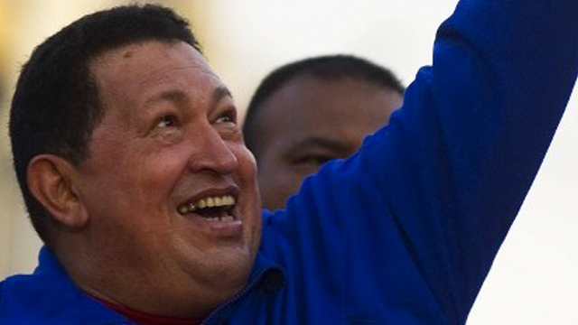 SWORN IN ALREADY? Venezuelan President Hugo Chavez greets supporters during a campaign rally in Monagas on September 28, 2012. AFP PHOTO/JUAN BARRETO