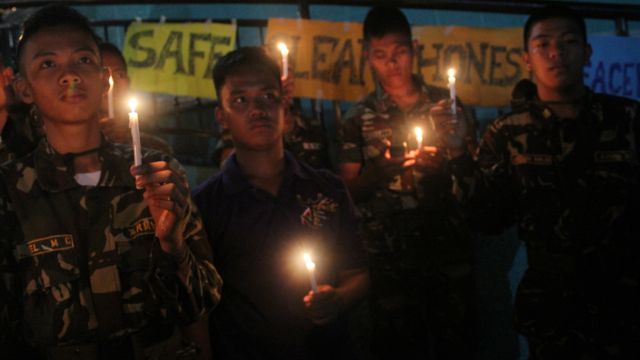 ARMY MOURNS. The Philippine Army in Bicol holds up candles and prays for safe elections. Photo by Rhaydz Barcia