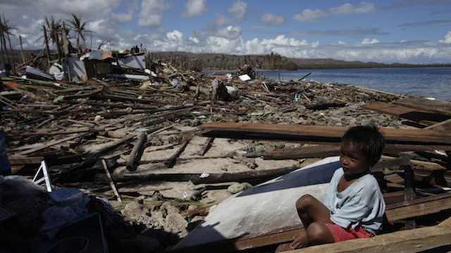 SOLACE. A child manages a smile amid the devastation. Photo by John Javellana