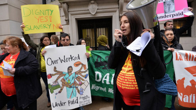 CONTROVERSY. Yomara Velez (R) speaks to a group supporting domestic workers' rights as they demonstrate across the street from the Indian Consulate General December 20, 2013 in New York. Photo by AFP