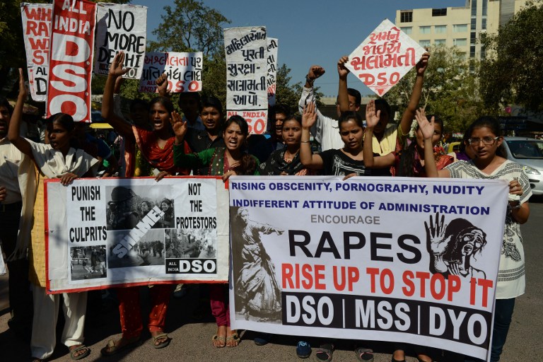'STOP THE RAPES' Members from The All India Democratic Students' Organization hold posters as they take part in a protest in Ahmedabad on December 24, 2012, following the gang rape of a student last week in the Indian capital. AFP PHOTO / Sam PANTHAKY