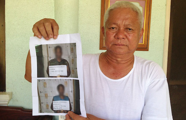 GUN BAN VIOLATION. Re-electionist Inopacan, Leyte Mayor Silvestre Lumarda shows mugshots of his opponent's driver and companion charged with gun ban violation. Photo by Jed Cortes