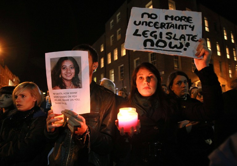 FOR ABORTION. Protestors hold pictures of Indian Savita Halappanavar, who was allegedly refused a pregnancy termination after doctors told her it was a Catholic country, as they gather outside Leinster House (Irish Parliament building) during a demonstration in favor of abortion legislation in Dublin, Ireland, on November 14, 2012. AFP PHOTO/ PETER MUHLY