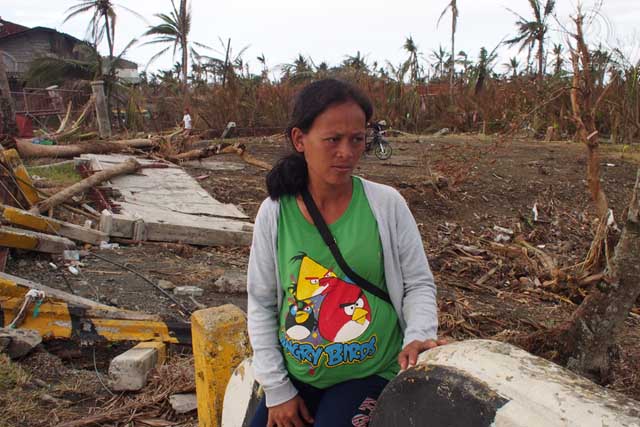 JOY WAITING. Eight-months-pregnant Joy Marabot sits in the devastation of Sto. Nino, Tanauan, Leyte. Photo by Jake Verzosa