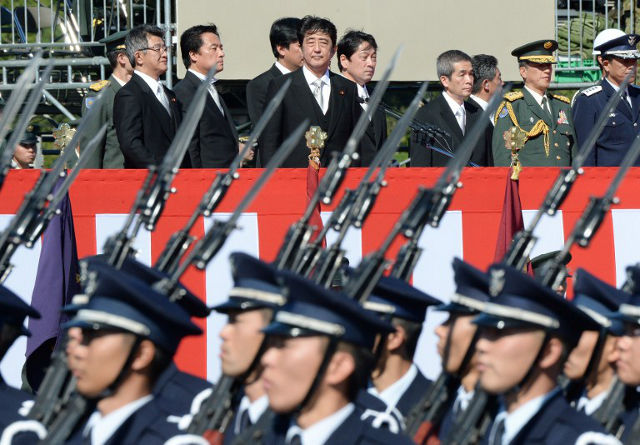 MORE TROOPS. Japanese Prime Minister Shinzo Abe inspects troops of Japan's Self-Defence Force on October 27, 2013. Photo by Toru Yamanaka/AFP FILE PHOTO