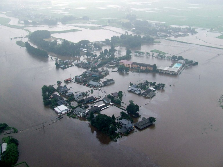 This handout picture released from Kumamoto Fire Department on July 12, 2012 and given to AFP via JIJI Press shows an aerial view of a residential area affected by flood waters left by torrential rain at Aso city in Kumamoto prefecture, on Japan's southern island of Kyushu. AFP PHOTO / KUMAMOTO FIRE DEPARTMENT via JIJI PRESS 
