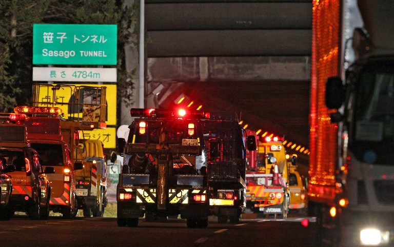 Operation vehicles continue with the rescue as they enter the Sasago tunnel along the Chuo highway near the city of Otsuki in Yamanashi prefecture, 80 kms west of Tokyo on December 2, 2012 after part of the tunnel collapsed. AFP PHOTO / JIJI PRESS