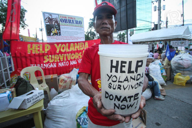 GETTING HELP. Karlos Trangia helped in going around barangays to ask for donations for Typhoon Yolanda survivors. Photo by Karlos Manlupig/Rappler