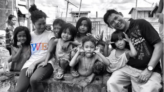 WE CAN MAKE A DIFFERNCE. Manuel and fellow Smokey Mountain advocate Cecilia Martinez-Miranda playfully pose with children from the community. Photo by Mik Bjorkenstam