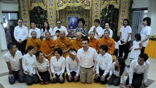 FAMILY PICTURE. Family members of late Liem Sioe Liong, also known by his Indonesian name Soedono Salim, pose with Buddhist monks for a family picture at the wake in Singapore on June 12, 2012. Photo by AFP