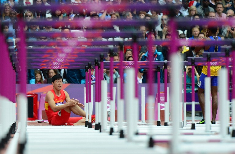 China's Liu Xiang reacts after falling while competing in the men's 110m hurdles heats at the athletics event during the London 2012 Olympic Games on August 7, 2012 in London. AFP PHOTO / OLIVIER MORIN