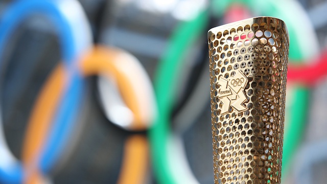 A prototype of the London 2012 Olympic Torch, with the Olympic Rings at the background, 8 June 2011. Photo courtesy of LOCOG.