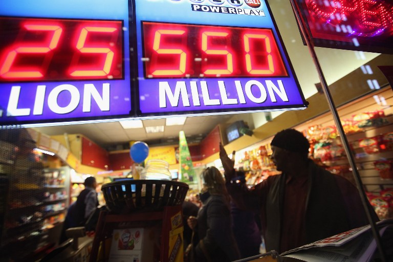 A sign outside the One Stop Mart shows the winning amounts for lottery games including the $550 million for the Powerball jackpot on November 28, 2012 in Chicago, Illinois. A single Powerball winner would get a lump sum payment of about $360.2 million before taxes. Scott Olson/Getty Images/AFP