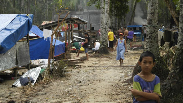 COMMUNITY IN RUINS. Residents of Luyong make do with makeshift tents and sharing whatever resources they have left.