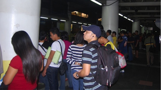 COMMUTE. Commuters await the train at the MRT station in Quezon City, Philippines. Photo by Raymond Virata