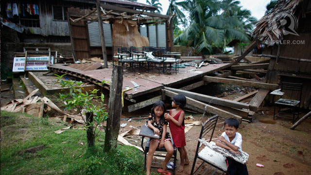 Students sit outside a shattered classroom in Mahayahay, Lingig, Surigao del Sur. 03 Jan 2013, Photo by John Javellana.