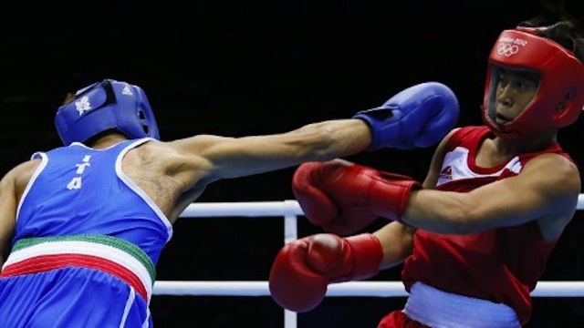 Philippines' Mark Barriga (in red) defends against Manuel Cappai (in blue) of Italy during their Light Flyweight boxing match of the London 2012 Olympics. Photo courtesy of AFP