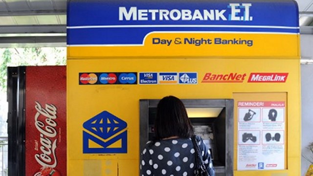 NO HIKE. The banking regulator orders industry players to defer increase in ATM fees. File photo by AFP