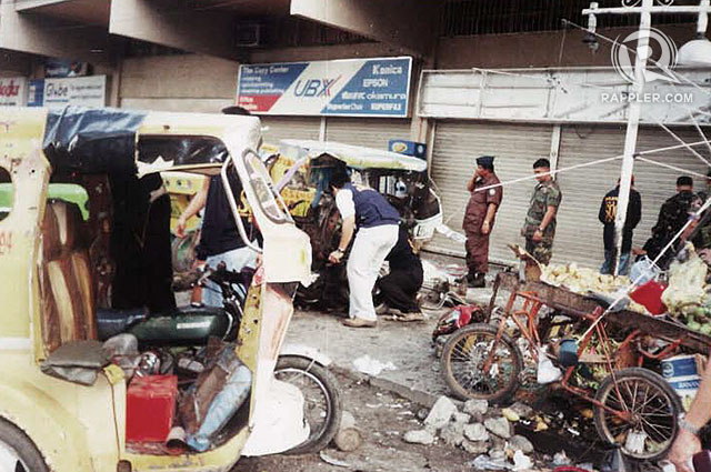 SEARCH. Investigators sift through the rubble after an explosion outside the Fitmart Department Store in April 2002. Photos by Edwin Espejo