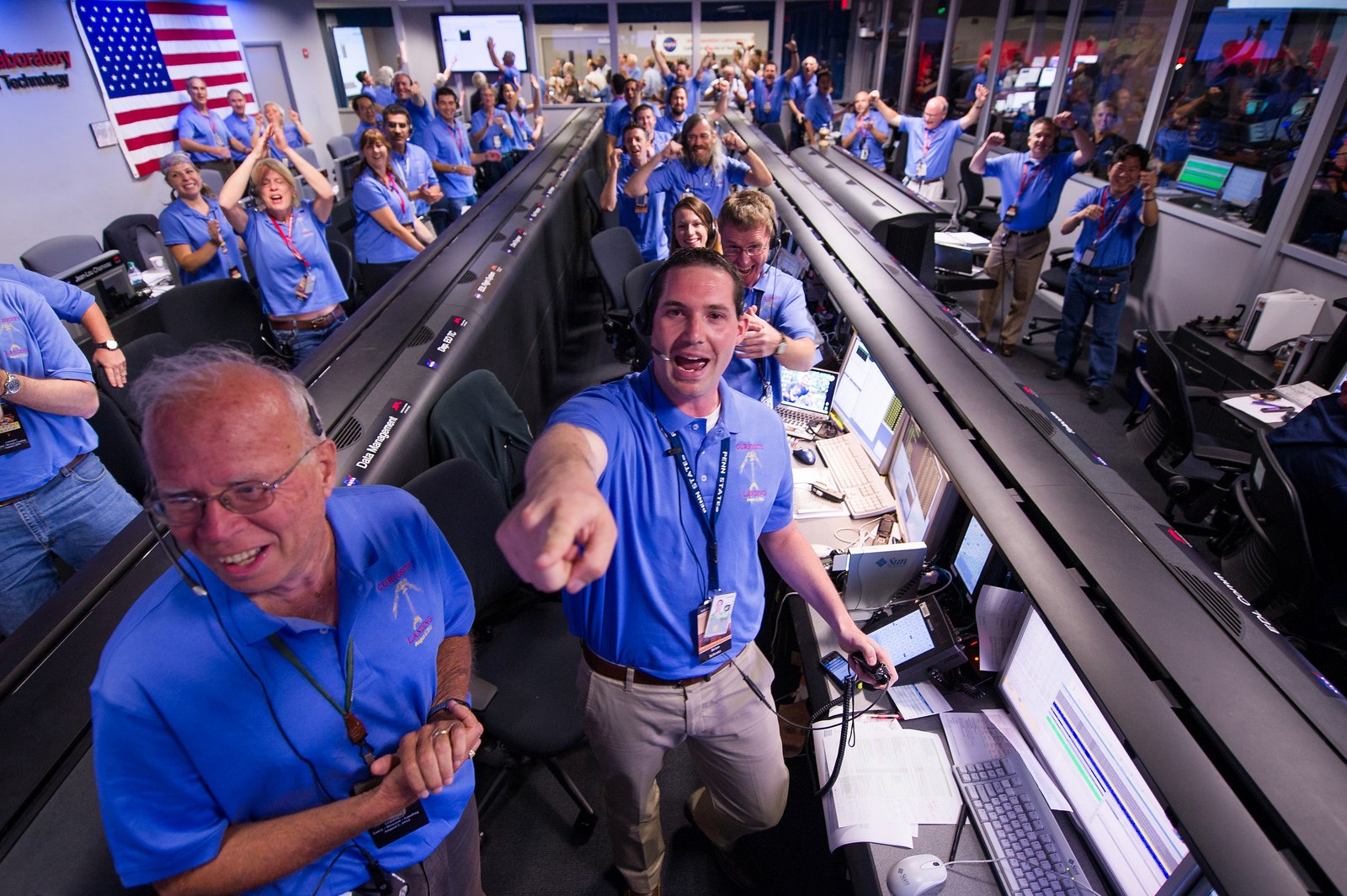 HISTORIC MOMENT. The Mars Science Laboratory (MSL) team in the MSL Mission Support Area reacts after learning the the Curiosity rover has landed safely on Mars and images start coming in at the Jet Propulsion Laboratory on Mars, Sunday, Aug. 5, 2012 in Pasadena, Calif. The MSL Rover named Curiosity was designed to assess whether Mars ever had an environment able to support small life forms called microbes. Photo Credit: NASA/Bill Ingalls