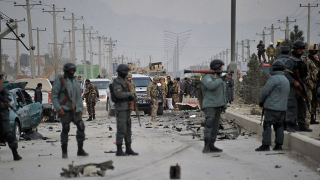 LEAVING. NATO forces and Afghan security forces investigate a suicide attack. Aid groups are determined to avoid following NATO as they prepare to leave Afghanistan. Noorullah Shirzada/AFP Photo
