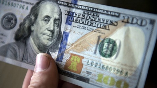 NEW BILL. The new 2009 series $100 bill includes new security features such as a band with moving images, ink that changes color with the angle as well as a new design. Photo by AFP