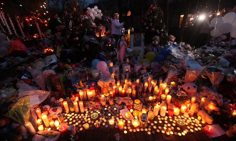 IN REMEMBRANCE. Candles are lit among mementos at a memorial for victims of the mass shooting at Sandy Hook Elementary School, on December 17, 2012 in Newtown, Connecticut. The first two funerals for victims of the shooting were held today. Mario Tama/Getty Images/AFP