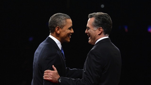 Republican presidential candidate Mitt Romney (R) and US President Barack Obama (L) greet one another at Magness Arena moments before the start of their first debate at the University of Denver in Denver, Colorado, October 3, 2012. AFP PHOTO / Pool / Michael REYNOLDS