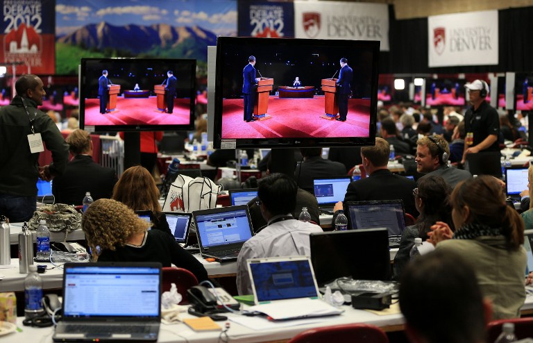Reporters watch the final minutes of the Presidential Debate between Democratic presidential candidate, U.S. President Barack Obama and Republican presidential candidate, former Massachusetts Gov. Mitt Romney at the University of Denver on October 3, 2012 in Denver, Colorado. Doug Pensinger/Getty Images/AFP