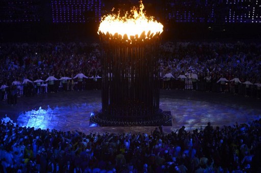 OLYMPIC CAULDRON. Athletes gather around the Olympic flame at the end of the opening ceremony of the London 2012 Olympic Games on July 27, 2012 at the Olympic stadium in London. AFP Photo / John MacDougall