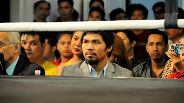 SUPPORTER. Manny Pacquiao looks on as Dennis Laurente and Eusebio Baluarte fight for the Philippine Welterweight title. March 26, 2012. Hanz Lustre.