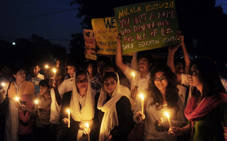 FOR MALALA. Pakistani civil society activists carry candles to pay tribute to gunshot victim Malala Yousafzai and protest against her assassination attempt, in Lahore on October 10, 2012. AFP PHOTO/ Arif Ali