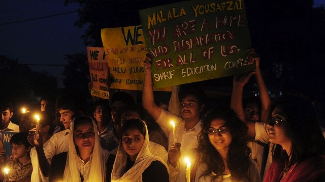 FOR MALALA. Pakistani civil society activists carry candles to pay tribute to gunshot victim Malala Yousafzai and protest against her assassination attempt, in Lahore on October 10, 2012. AFP Photo/Arif Ali 