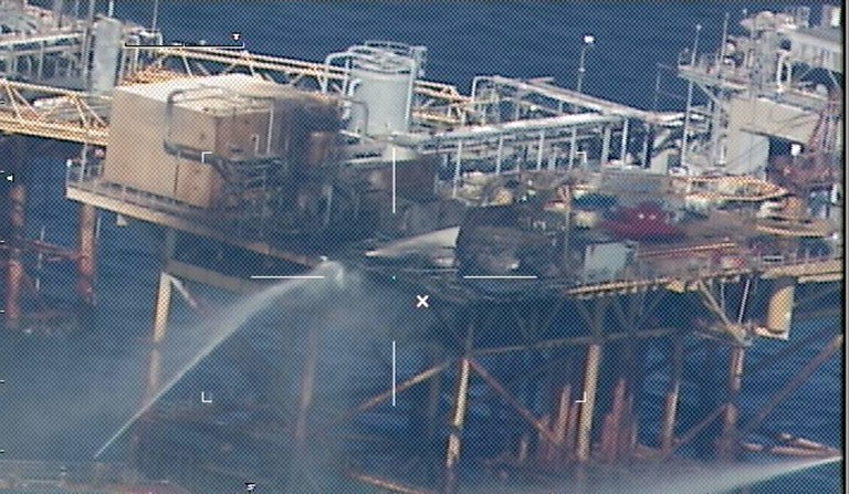 RIG FIRE. Commercial vessels spray water to extinguish a platform fire on board the West Delta 32 oil rig in the Gulf of Mexico off Grand Isle, Louisiana on November 16, 2012. AFP PHOTO / HNADOUT / US COAST GUARD