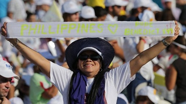 FAITHFUL. A Filipino woman holds a banner as she attends a mass led by Pope Benedict XVI in Beirut's waterfront on September 16, 2012, on the final day of his visit to Lebanon. Photo by AFP
