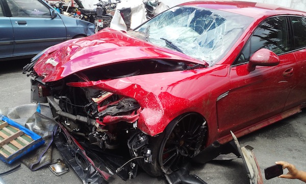 KILLER PORSCHE. The red luxury car driven by a Belgian resident in Subic overtook a tricycle and collided with two others, killing the drivers. Photo by Randy Datu/Rappler