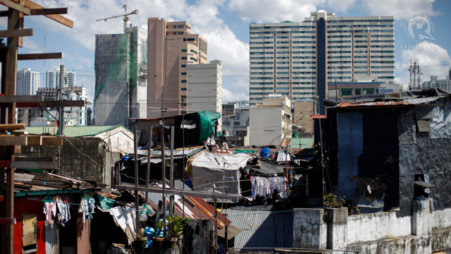 High-rise construction provides a contrasting background for the shanties in Metro Manila.