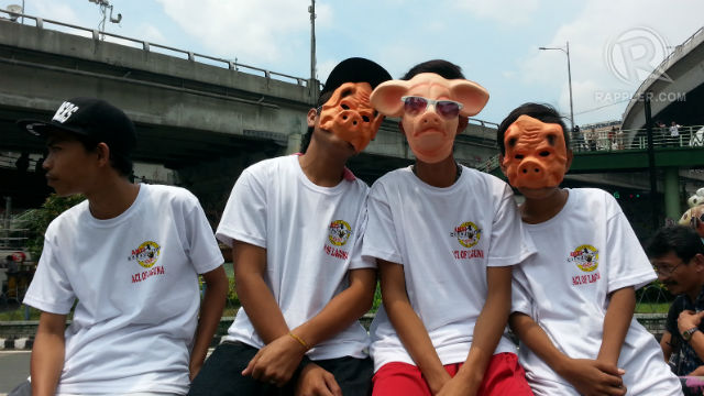 SAD FACE. Four boys wear pig masks during the protest against pork barrel in Edsa. Photo by Sreychea Heang/Rappler
