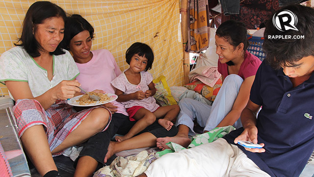AMONG 20,000. Putli Suhaili and her children in their shelter at the Joaquin F Enriquez Memorial Stadium, that hosts the biggest number of evacuees in Zamboanga City. Photo by Gemma Cortes/OCHA