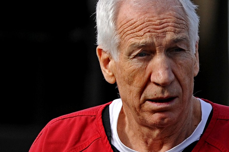 SENTENCED. Former Penn State assistant football coach Jerry Sandusky leaves the Centre County Courthouse after being sentenced in his child sex abuse case on October 9, 2012 in Bellefonte, Pennsylvania. Patrick Smith/Getty Images/AFP